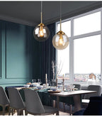 Modern nordic glass pendant lamp hanging above wooden dining table casting warm diffused light in minimalist Scandinavian dining room