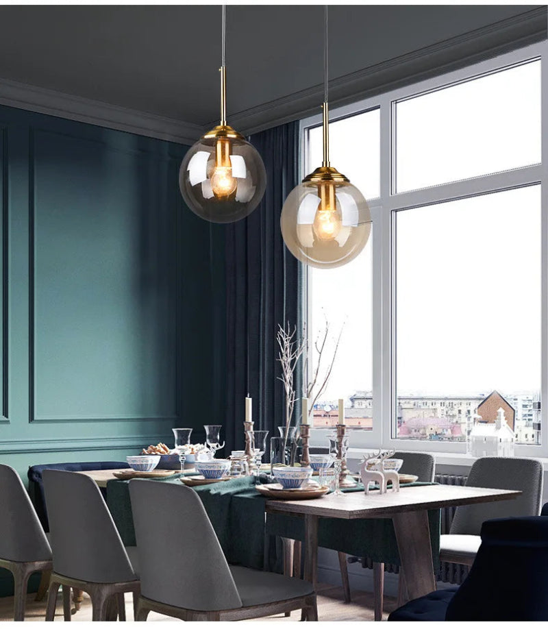Modern nordic glass pendant lamp hanging above wooden dining table casting warm diffused light in minimalist Scandinavian dining room
